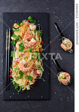Noodles and prawns, vegetables on a black stone Noodles and prawns, vegetables on a black stone 35594404