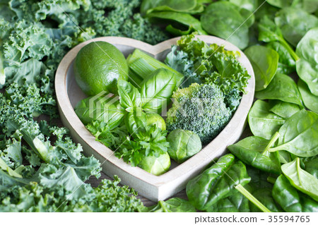 Green vegetables and herbs in heart health concept 35594765