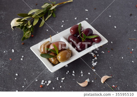 Black and green olives on a white plate Black and green olives on a white plate 35595510