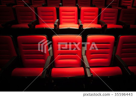 Red seat in the movie theater. Blurry background. Red seat in the movie theater. Blurry background. 35596443