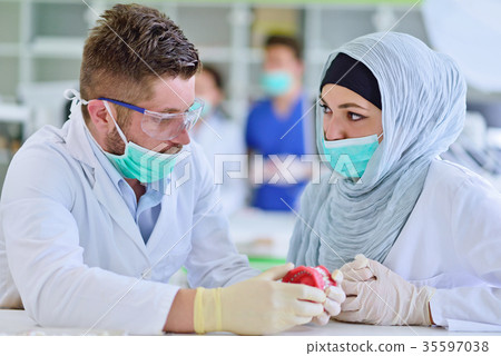 Arab students with hijab while working on the Arab students with hijab while working on the 35597038