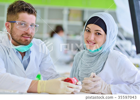 Arab students with hijab while working on the 35597043