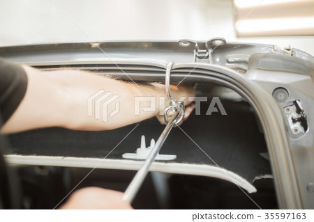 Repairing dents in a car Repairing dents in a car 35597163