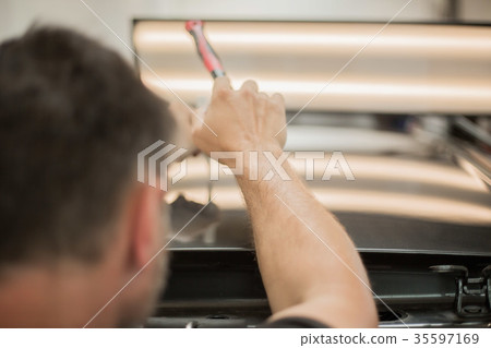 Repairing dents in a car Repairing dents in a car 35597169