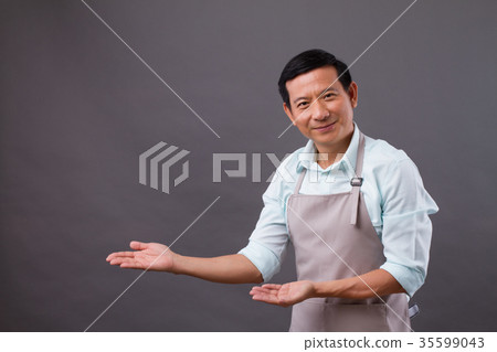 confident man shopkeeper pointing hand up to side confident man shopkeeper pointing hand up to side 35599043