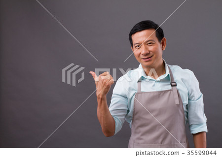 happy man shopkeeper pointing thumb up to space happy man shopkeeper pointing thumb up to space 35599044