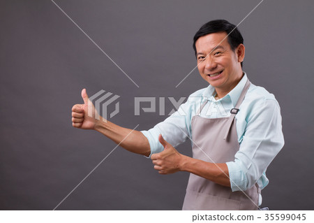excited man shopkeeper pointing thumb up to space excited man shopkeeper pointing thumb up to space 35599045
