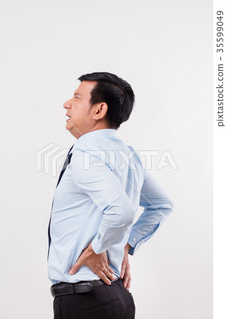 business man suffering from back pain or injury business man suffering from back pain or injury 35599049