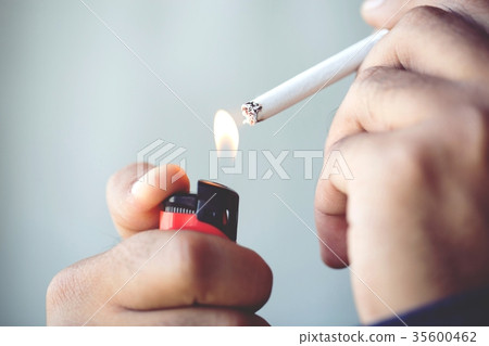 Male handle use lighters going to smoking a cigare 35600462