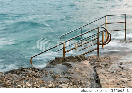 Swim ladder leading to stormy mystic sea Swim ladder leading to stormy mystic sea 35600848