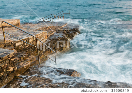 Swim ladder leading to stormy mystic sea 35600849
