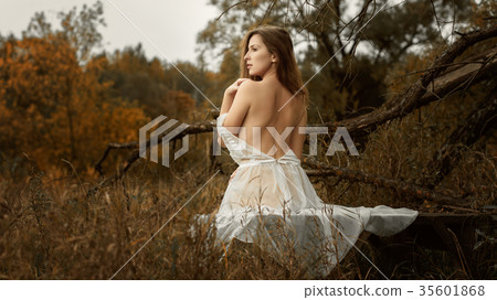 Beautiful girl in a white dress and autumn Beautiful girl in a white dress and autumn 35601868