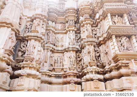 Ancient bas-relief at temple in Khajuraho, India. Ancient bas-relief at temple in Khajuraho, India. 35602530