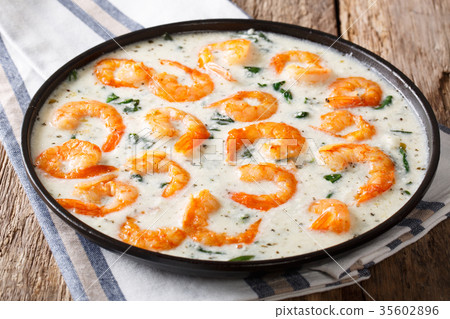 Shrimp with spinach and spices in creamy cheese 35602896