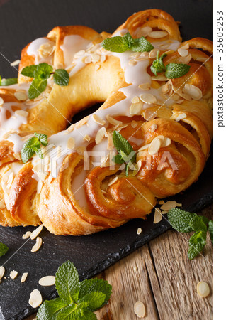 Festive sweet brioche with glaze and almonds 35603253