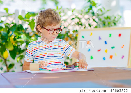 little school kid boy with glasses holding wax little school kid boy with glasses holding wax 35603872