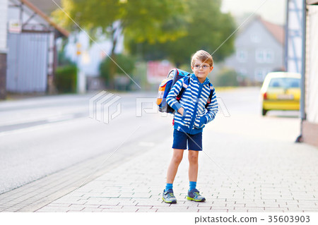 little kid boy with school satchel on first day to 35603903