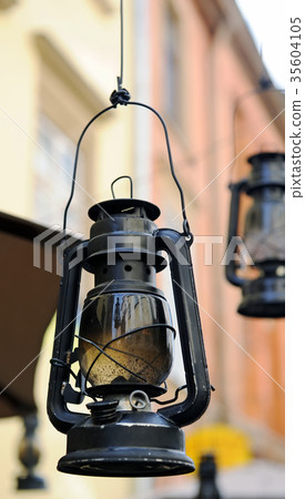 Kerosene lamp on the background of the old house Kerosene lamp on the background of the old house 35604105