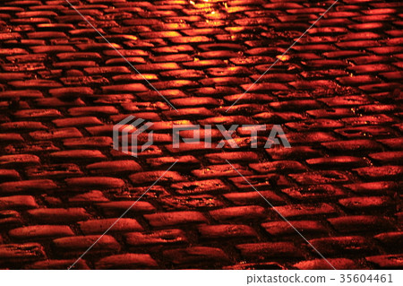 road pavement made from stone blocks in red lights road pavement made from stone blocks in red lights 35604461