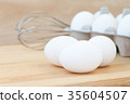 raw chicken eggs in egg box on wooden background 35604507