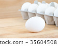 raw chicken eggs in egg box on wooden background 35604508