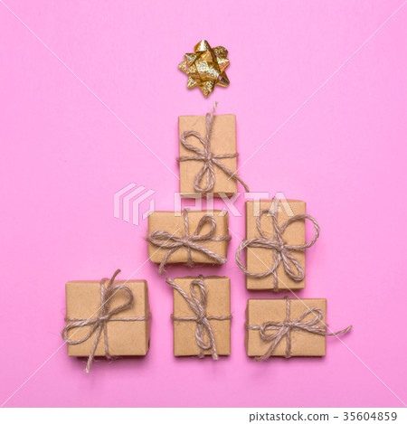Creative concept with gift boxes. Christmas tree of gifts on a pink background 35604859