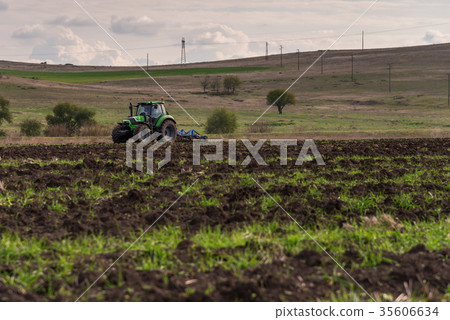 Tractor plowing fields. Tractor plowing fields. 35606634