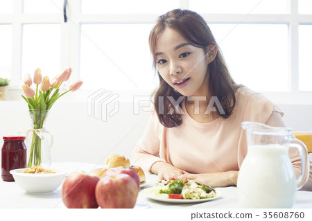 Young woman, food, staring Young woman, food, staring 35608760