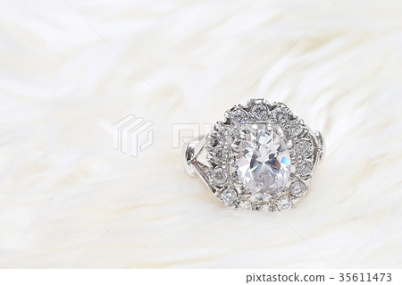 diamond ring on white fabric background 35611473