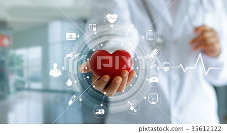 Doctor holding red heart shape and icon medical Doctor holding red heart shape and icon medical 35612122