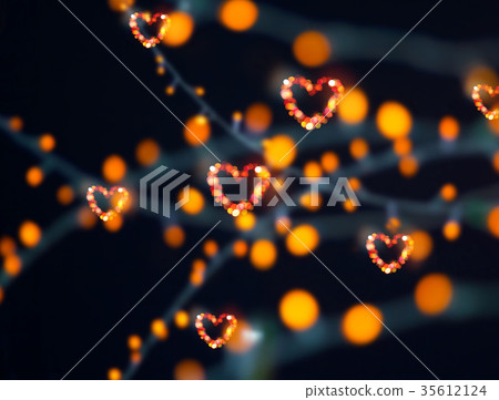 Abstract colorful bokeh lights heart shape on dark Abstract colorful bokeh lights heart shape on dark 35612124