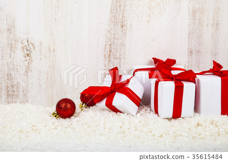 Gifts with red bows on snow Gifts with red bows on snow 35615484