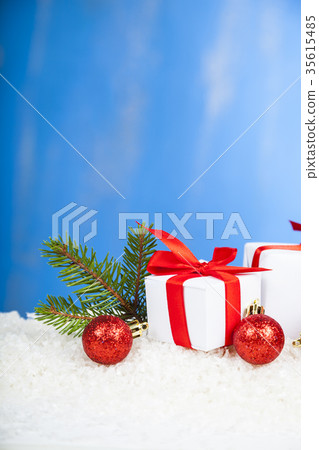 Gifts with red bows on snow 35615485