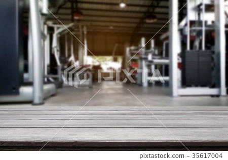 Wooden table on blurred background of fitness gym interior of mo 35617004