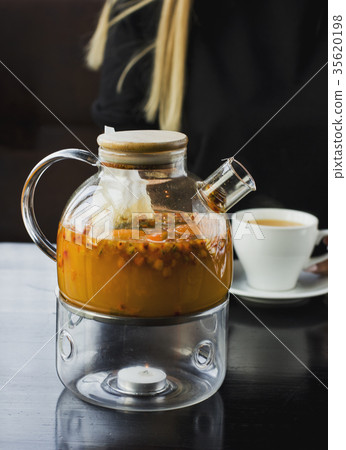 Sea buckthorn tea in glass teapot 35620198
