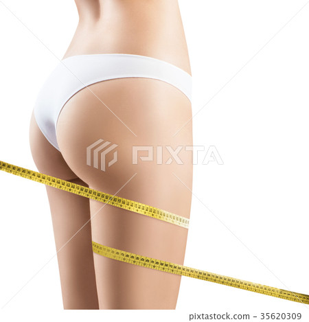 Female legs with measuring tape. Female legs with measuring tape. 35620309
