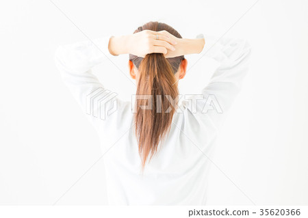 A woman holding her hair A woman holding her hair 35620366
