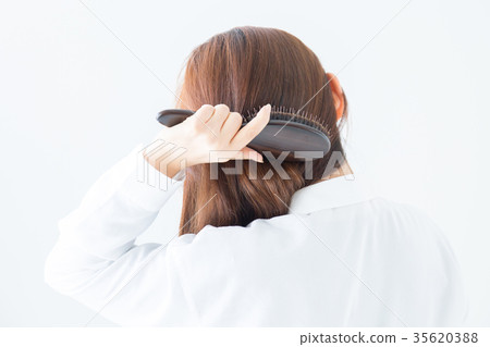 Woman combing hair 35620388