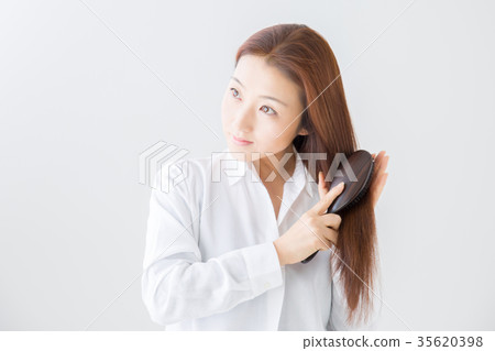 Woman combing hair 35620398