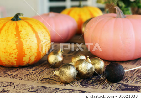 Painted pumpkins and gold garnets on craft paper 35621338