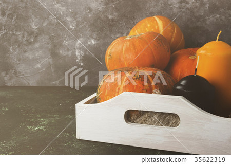 Ripe pumpkins, orange and black candle Ripe pumpkins, orange and black candle 35622319
