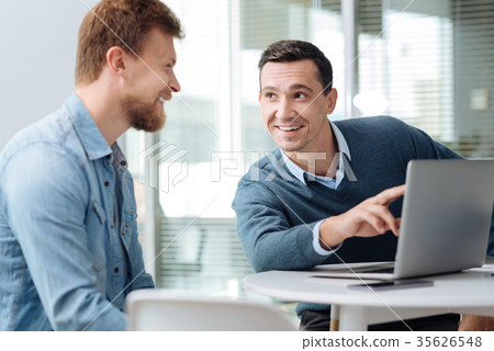 Smiling brunette talking to his new colleague Smiling brunette talking to his new colleague 35626548