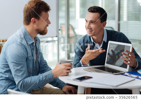 Cheerful brunette demonstrating his company 35626565