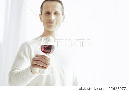Close up of male hand that holding bocal of wine Close up of male hand that holding bocal of wine 35627077