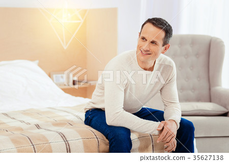 Dreamy male person sitting in his room Dreamy male person sitting in his room 35627138