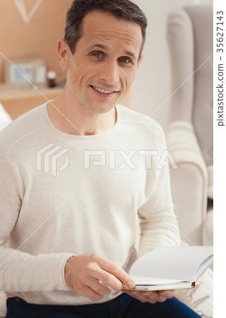 Handsome man looking straight at camera Handsome man looking straight at camera 35627143