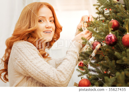 Charming woman getting festive for christmas 35627435