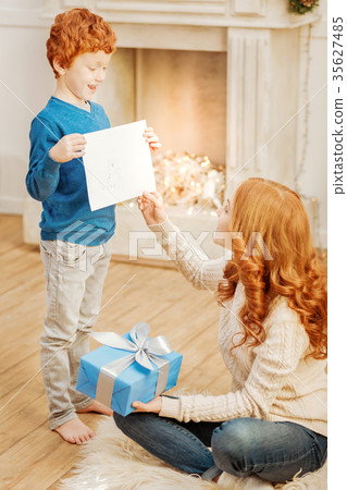 Adorable ginger child demonstrating drawing of Adorable ginger child demonstrating drawing of 35627485