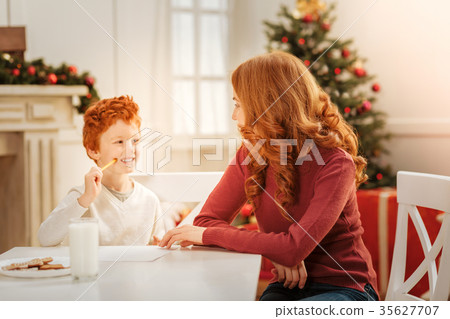 Positive minded family writing letter to santa 35627707