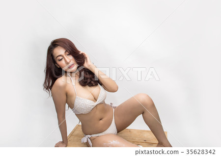 Beautiful girl in swimwear is applying sunscreen. Beautiful girl in swimwear is applying sunscreen. 35628342